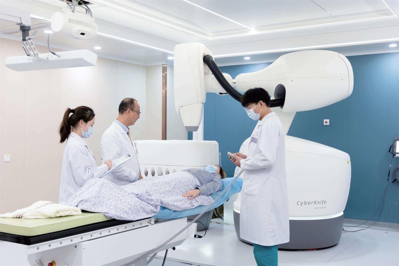 A clinical team positioning a patient for a CyberKnife session