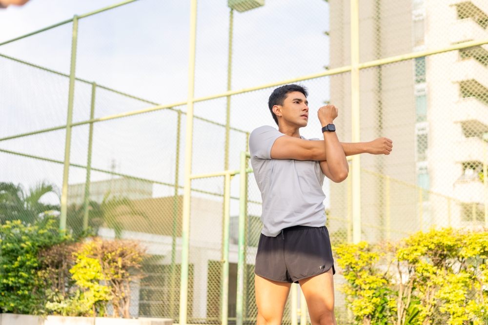 An active man stretching outdoors before exercise
